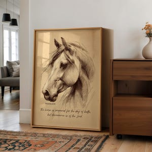 May include: A framed print featuring a detailed pencil sketch of a horse's head. The artwork is in sepia tones and includes the text "Proverbs 21:31" and a quote about preparation and deliverance. The frame is a light brown color.