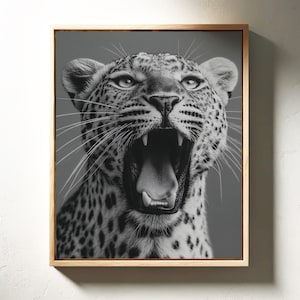 May include: Black and white framed print of a leopard with its mouth wide open, showcasing its teeth and tongue. The leopard's spotted fur is detailed, and the image is set against a gray background.