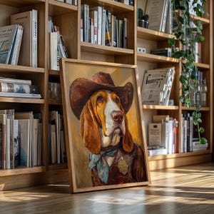 May include: A framed portrait of a Basset Hound wearing a cowboy hat, vest, and a blue bandana. The dog has brown and white fur and a serious expression. The artwork is displayed on a wooden floor in front of a bookshelf.