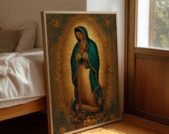 May include: A framed religious artwork depicting a figure in a teal cloak and gold dress, hands clasped in prayer. The artwork has a golden halo and is set against a detailed, ornate background with floral accents. The frame is a light wood color.