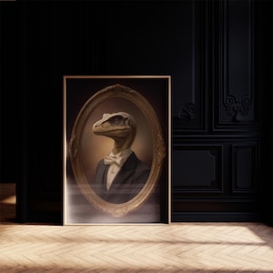 May include: A framed portrait of a dinosaur in a suit and bow tie. The artwork features a raptor-like creature with a serious expression, set against a dark background. The frame is gold-colored and oval-shaped, adding a touch of vintage elegance.