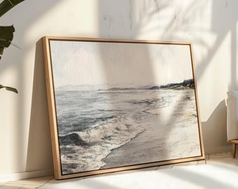 Puede incluir: Una pintura de acuarela enmarcada de una escena de playa. La obra representa olas rompiendo en la orilla, con una playa de arena y montañas distantes. La paleta de colores es principalmente de azules, grises y beige apagados, creando un sereno paisaje costero.