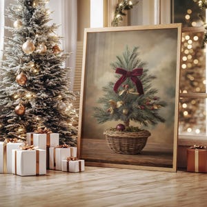 May include: A framed Christmas tree painting with a red velvet bow and ornaments. A decorated Christmas tree with gold ornaments and lights stands to the left. White gift boxes with gold ribbon are on the floor.