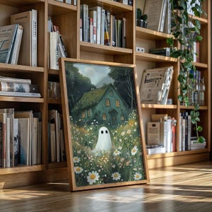 May include: A framed art print depicting a teal house with lit windows, a field of daisies, and a friendly ghost. The artwork is set against a backdrop of lush greenery and a cloudy sky. The frame is made of light-colored wood.