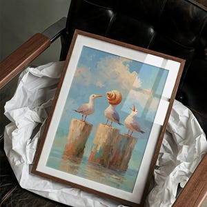 May include: Framed art print featuring three seagulls perched on wooden posts in the water. The artwork has a light blue sky background with clouds. The seagulls are white with orange beaks and feet. The frame is brown.
