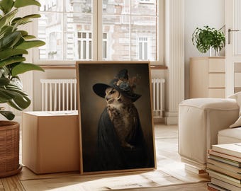 May include: A framed print featuring an owl dressed in a black witch's hat decorated with flowers. The owl is wearing a dark cloak, set against a warm, neutral backdrop. The artwork is displayed on a wooden floor.