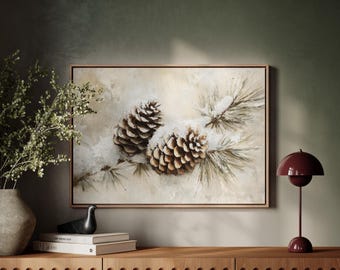 May include: A painting of two pine cones covered in snow on a branch. The background is a light beige color. The painting is framed in a light wood frame.