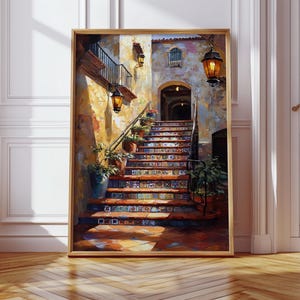 May include: A framed art print showing a sunlit exterior staircase in a Mediterranean style. The steps are decorated with colourful tiles, potted plants, and wrought iron railings. Lanterns hang from the walls, casting warm light. The artwork is set in a wooden frame.