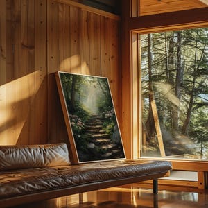 May include: A framed painting of a stone path leading through a lush green forest with a soft, ethereal light shining through the trees.