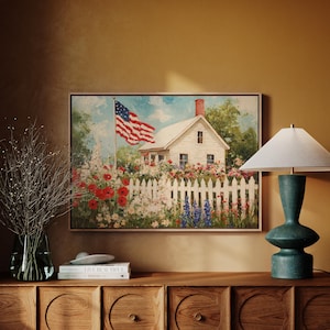 May include: A painting of a white house with a red, white, and blue American flag flying in front of it. The house is surrounded by a white picket fence and a garden of colorful flowers.