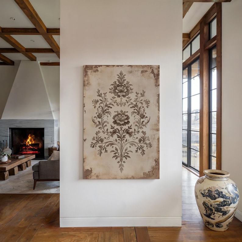 May include: A brown and white floral patterned canvas wall art hanging on a white wall in a modern home interior. The art is framed with a thin, brown wooden frame.