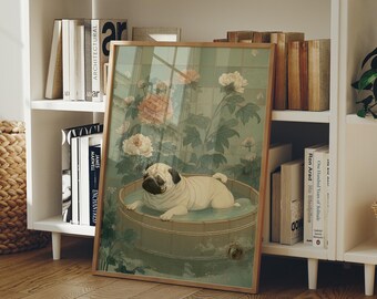 May include: A framed art print featuring a pug dog relaxing in a wooden tub filled with water. The artwork has a vintage aesthetic with floral and botanical elements in shades of green, pink, and cream. The print is displayed on a white shelf with books.