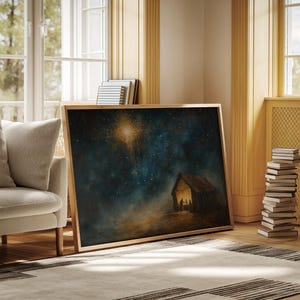 May include: A framed painting depicting a nighttime scene with a bright star shining over a stable. The stable is lit from within and three figures are visible inside. The sky is dark blue with many stars.