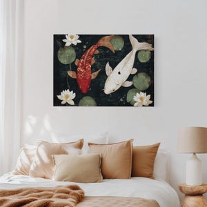 May include: A rectangular canvas print featuring two koi fish swimming in a pond with lily pads and white lotus flowers. One koi is red, the other is white with black spots. The background is dark green.