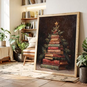 May include: A framed painting depicts a Christmas tree made of stacked books. The books are various colors, including red, green, and brown. A gold star sits atop the tree, with pine branches and string lights adding detail.