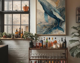 May include: A framed watercolor painting of a blue whale swimming in a sea of blues and golds. A bar cart with various bottles of liquor and glassware is in the foreground. A large window with plants sits to the left.