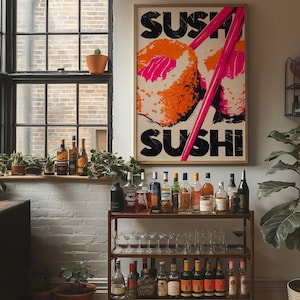 May include: A framed "SUSHI" poster with a graphic of sushi rolls and pink chopsticks hangs above a bar cart. The cart holds various bottles of liquor and glassware. A window with plants and bottles sits to the left.