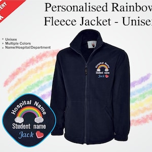 May include: A navy blue fleece jacket with a full zip and a high collar. The jacket features a rainbow design and the text "Personalised Rainbow Fleece Jacket - Unisex". The jacket has a patch with a rainbow and the text "Hospital Name" and "Student name Jack".