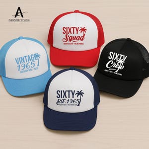May include: Four trucker caps with white fronts and mesh backs. One is light blue with "VINTAGE 1965" text, another is red with "SIXTY Squad" text, a black hat with "SIXTY Crew" text, and a navy hat with "SIXTY Est. 1965" text.