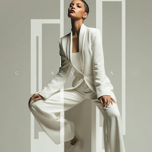 May include: A woman in a white suit poses against a gray background with geometric shapes. The suit includes a blazer, top, and wide-leg pants. The model wears white heels and has short hair. The word "CAYA" is visible in the image.