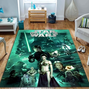 Op de afbeelding: Een groen en blauw tapijt met een Star Wars: Return of the Jedi-thema. Het tapijt toont personages uit de film, waaronder Luke Skywalker, Prinses Leia, Han Solo en Darth Vader. De tekst "Star Wars: Return of the Jedi" is in wit op het tapijt gedrukt.