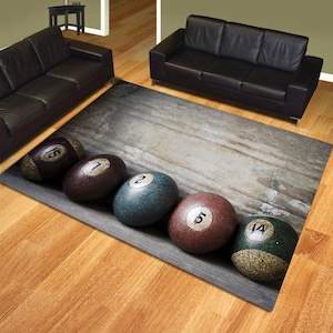 May include: A grey and brown rug with a woodgrain pattern and a row of five billiard balls with numbers 15, 1, 2, 5, and 14.