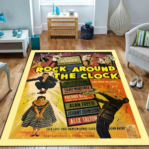 May include: A rectangular area rug featuring a vintage movie poster design for "Rock Around the Clock." The poster has a yellow background with text and illustrations of musicians. The rug is bordered by a yellow frame.
