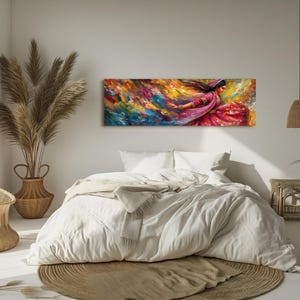 a bedroom with a large painting on the wall