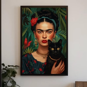May include: A framed wall art print featuring a portrait of a person with dark braided hair adorned with a red flower and a teal headband. The person wears gold jewellery and a dark floral top, holding a black cat with yellow eyes against a jungle background.