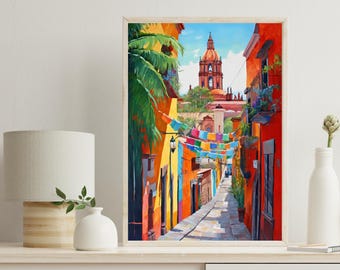 May include: A framed wall art print depicting a vibrant street scene with bright orange and yellow buildings, a tall church tower in the distance, lush green palm fronds, and colorful pennant flags strung across a narrow cobblestone path.