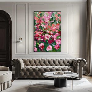 a living room with a couch and a painting on the wall