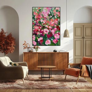 a living room filled with furniture and a painting on the wall