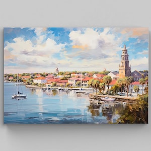 May include: A rectangular canvas print featuring an impressionistic painting of a coastal town with a tall church steeple, red-roofed buildings, palm trees, and a sailboat on calm blue water under a bright sky with large white clouds.