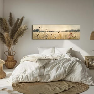 a bedroom with a large bed and a painting on the wall