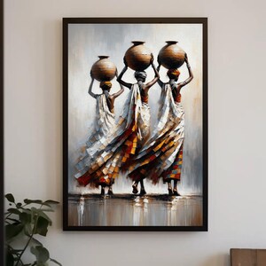 May include: A framed wall art print depicting three figures walking away, each balancing a large brown clay pot on their head. They wear flowing, layered garments in shades of white, orange, and blue, set against a neutral, textured background.
