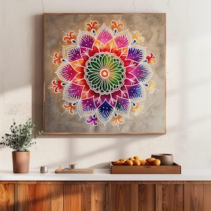 Op de afbeelding: Een vierkant, ingelijst kunstwerk met een levendig mandala-ontwerp. De mandala toont een symmetrisch patroon met een centrale groene bloem, omgeven door lagen kleurrijke bloemblaadjes in tinten roze, paars, oranje en blauw. Het kunstwerk staat tegen een neutrale achtergrond.