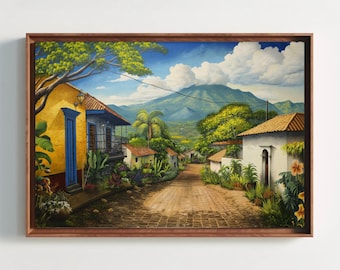 May include: A framed landscape painting depicting a cobblestone path winding through a village with yellow and white buildings, lush green trees, and vibrant flowers under a blue sky with white clouds, set against a large mountain in the distance.