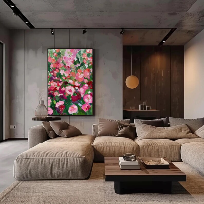 a living room filled with furniture and a painting on the wall