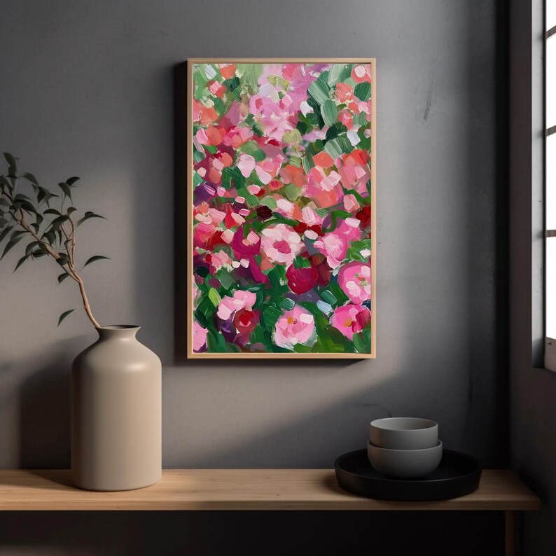 a painting hanging on a wall next to a vase