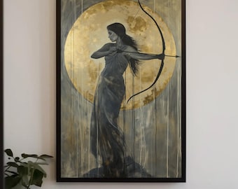 May include: A framed wall art print featuring a dark-haired figure in a flowing gown holding a bow and arrow. The figure is positioned against a large, textured gold circular background. Vertical paint drips in white and gold descend across the canvas.