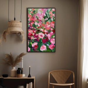 a painting hanging on a wall next to a chair