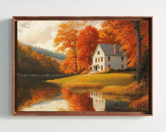May include: A framed landscape painting depicting a white house situated on a grassy bank beside a calm river. The scene is surrounded by dense trees with vibrant orange and yellow autumn foliage, with the reflection visible in the water.