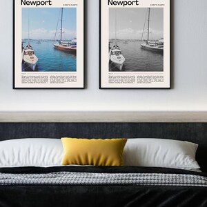 May include: Two framed Newport art prints. One print is in color, the other in black and white. Both feature a harbor scene with sailboats and the text "Newport" at the top. The prints are displayed above a bed with a yellow pillow.
