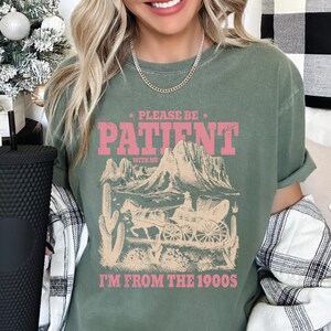 a woman with blonde hair wearing a green shirt