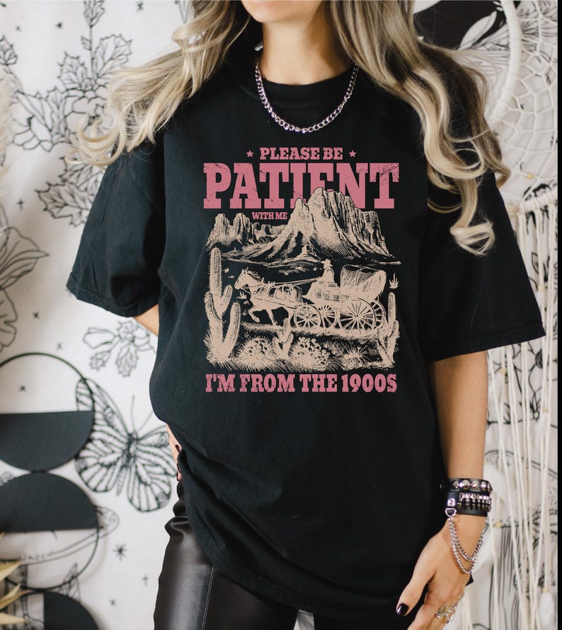 a woman wearing a black t - shirt with the words please to patient i '
