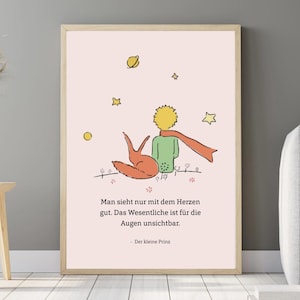 May include: A pink and white poster with a quote from The Little Prince. The quote reads: "Man sees only with his heart. What is essential is invisible to the eye." The poster features a cartoon illustration of The Little Prince sitting with a fox.