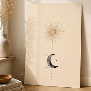 May include: A rectangular wall art print on a cream background featuring a centered vertical illustration of a golden sun with radiating lines positioned above a dark grey crescent moon, accented by small star symbols and thin vertical lines.