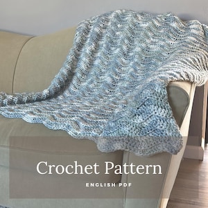 May include: A crochet pattern for a blue and white blanket, with the text "Crochet Pattern" and "ENGLISH PDF" on the bottom of the image.