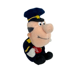 May include: A plush toy of a cartoon character wearing a blue and yellow uniform with a black hat. The character is holding a red sign that says "STOP".