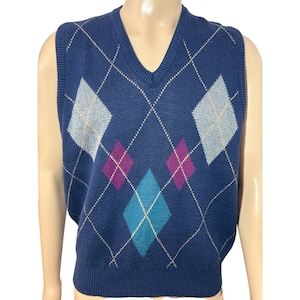 May include: A navy blue sleeveless sweater vest with a diamond pattern in shades of blue, teal, purple, and white.
